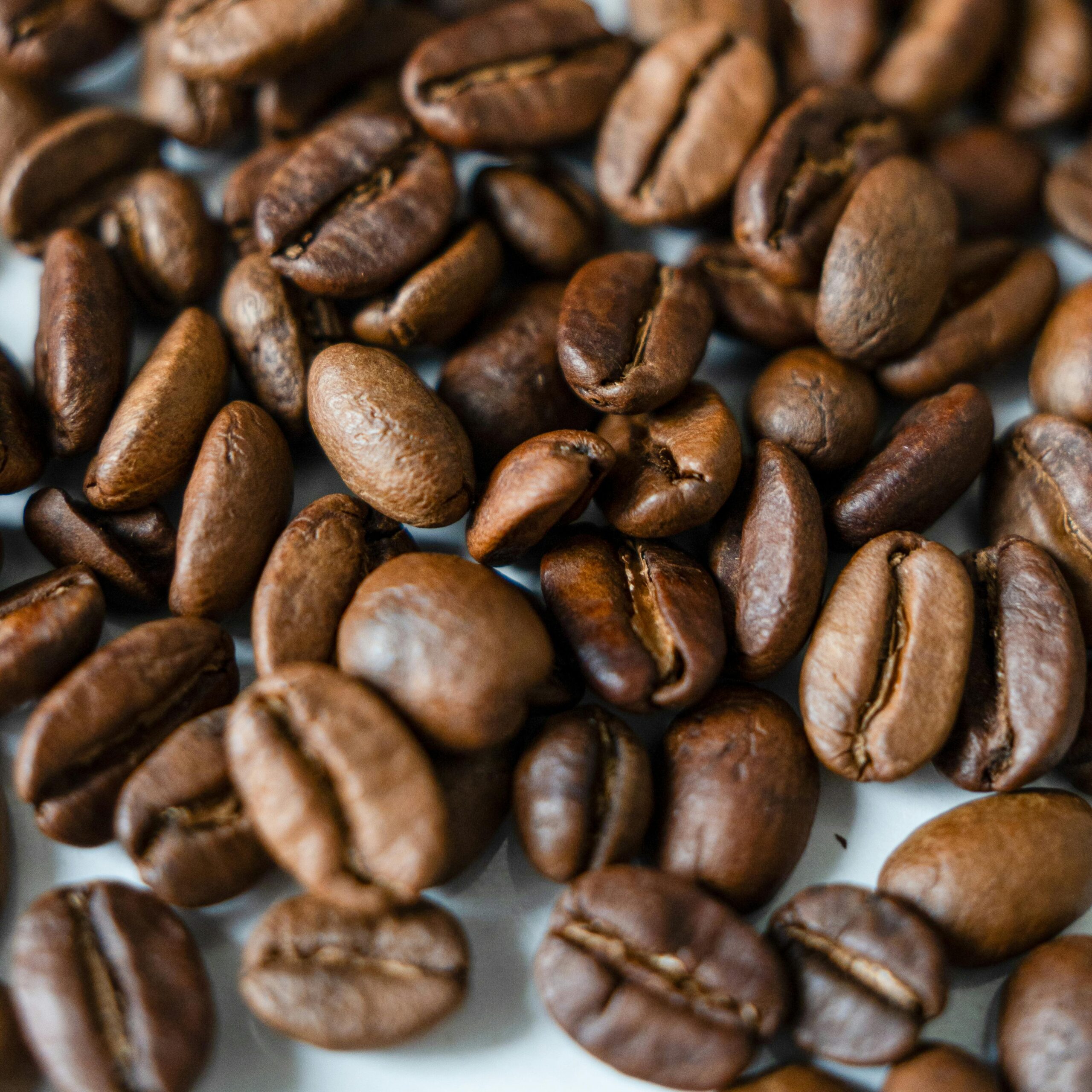 Detailed close-up shot of roasted coffee beans, perfect for food and beverage themes.